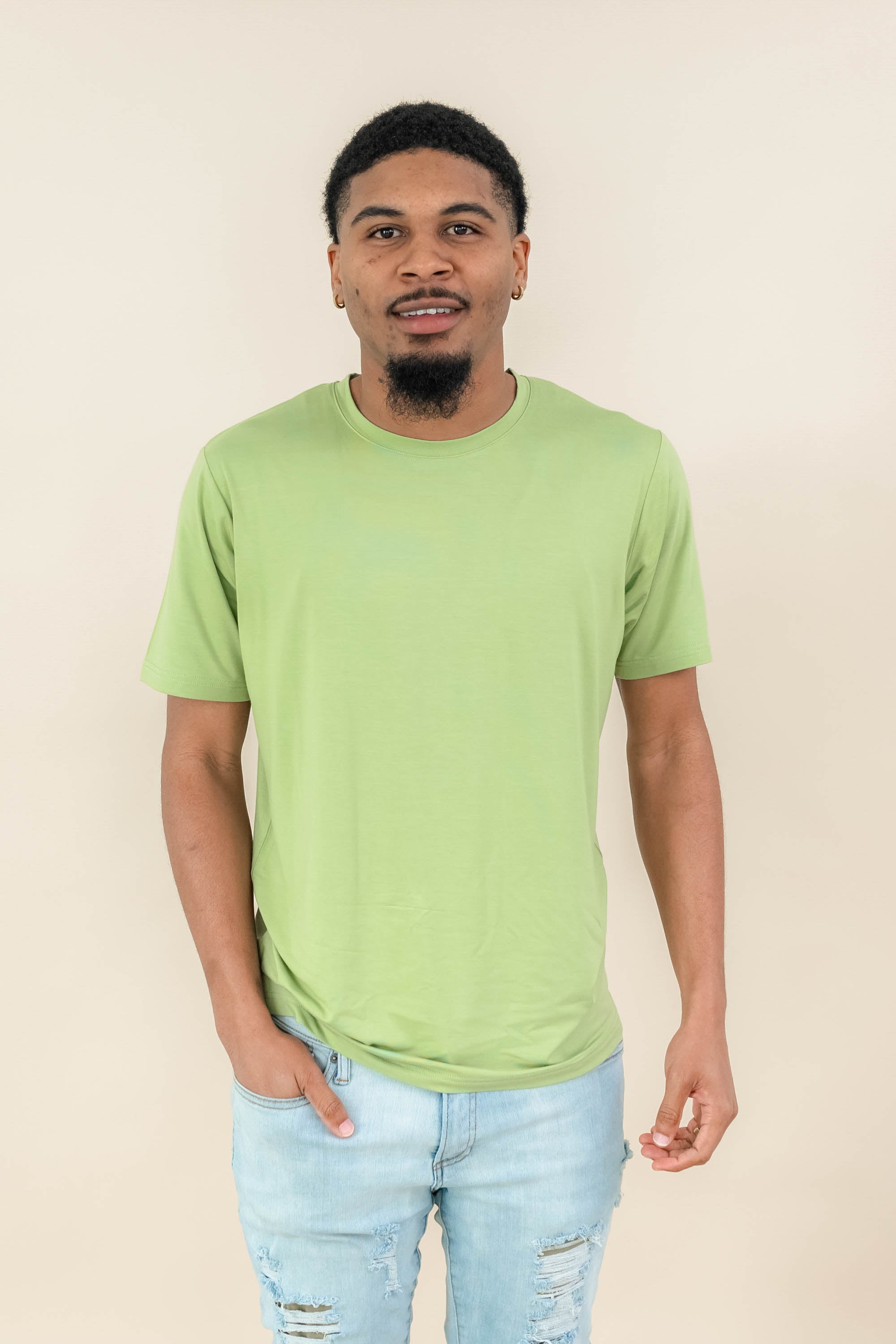 Male model wearing the Men's Crew Neck Tee in Honu in light wash jeans