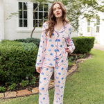 Woman outside with her leg propped and hand on her top in long sleeve pajamas in Hydrangea Sakura print.
---1605 3