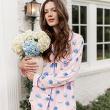 Woman outside holding a vase of hydrangeas in long sleeve pajamas in Hydrangea Sakura print.
 ---PJ 4