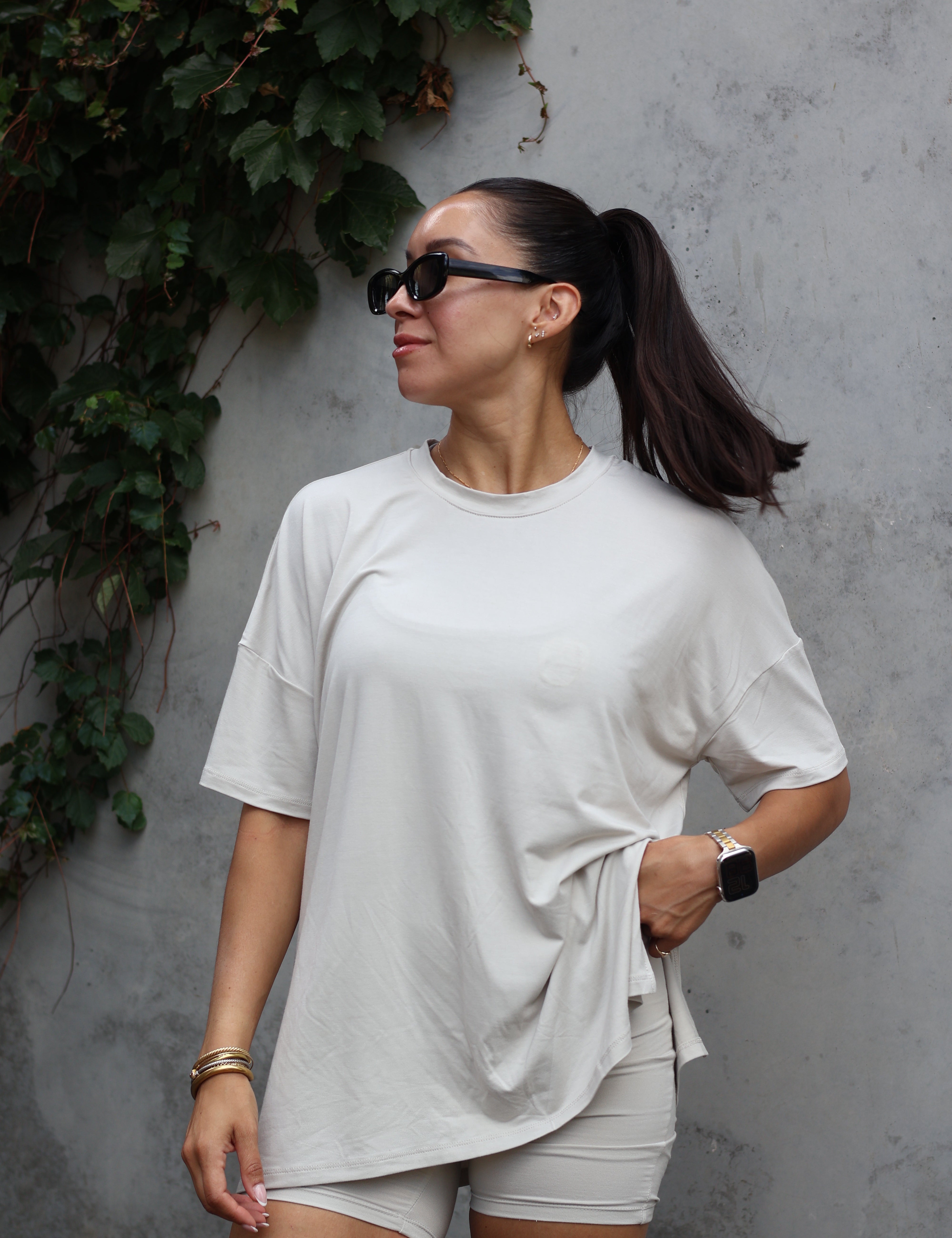 Woman modeling oat biker short set accessorized with sunglasses and jewelry 