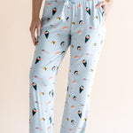 Model showing pockets of blue Women's Lounge Pants with drawstring in Sushi print under white camisole on a beige background