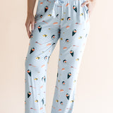 Model showing pockets of blue Women's Lounge Pants with drawstring in Sushi print under white camisole on a beige background