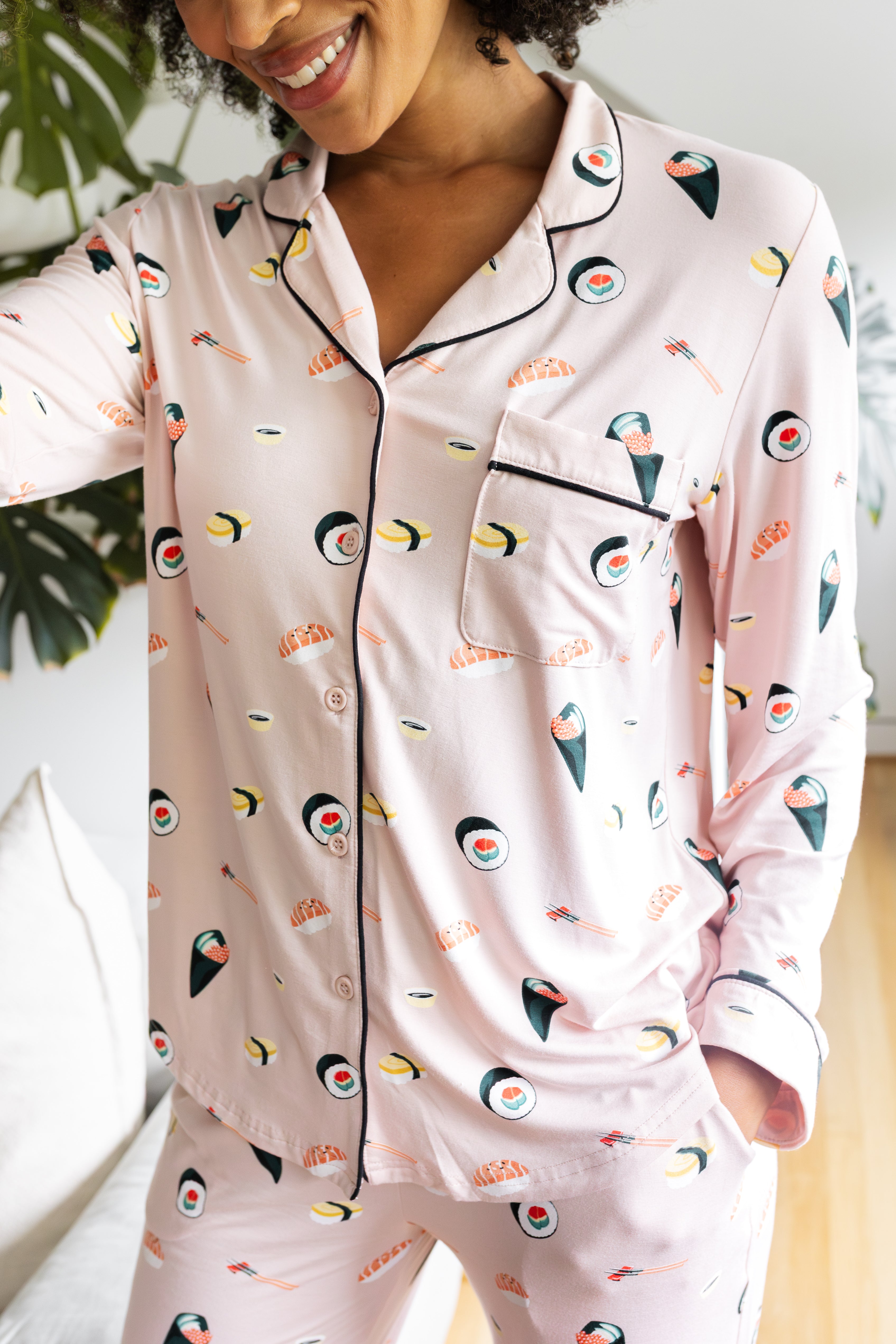 Person wearing a pink pajama set with sushi pattern
---PJ 2