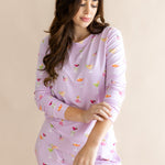 Model looking downwards with sleeves raised up from the Women's Jogger Pajama Set in Cocktail