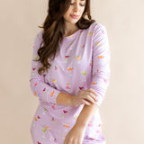 Model looking downwards with sleeves raised up from the Women's Jogger Pajama Set in Cocktail