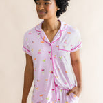 Smiling model looking to the side and close up of the top from the Women's Short Sleeve Cropped Pajama Set in Cocktail