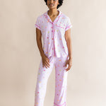 Model standing in front of a beige back ground while wearing the Women's Short Sleeve Cropped Pajama Set in Cocktail
::: Model is 5'9" wearing size S ///