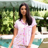 Close up of the model wearing the Women's Short Sleeve Pajama Set in Cocktail in front of a pool umbrella

::: Model is 5'10" wearing size S ///
