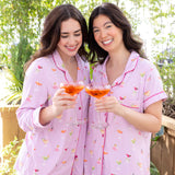 Smiling models with cock tails wearing the Long Sleeve Pajama Set and Women's Short Sleeve Pajama Set in Cocktail