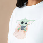 Close up of the Yoda character on a Women's Graphic Tee in The Child™