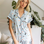 Woman wearing a sushi-themed pajama set in a home setting with plants. ::: Model is 5'11" wearing size S ///
---PJ 4
