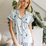 Woman wearing a sushi-themed pajama set in a home setting with plants. ::: Model is 5'11" wearing size S ///
---PJ 4
