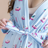 Light blue robe with mahjong print worn by a person, on a beige background