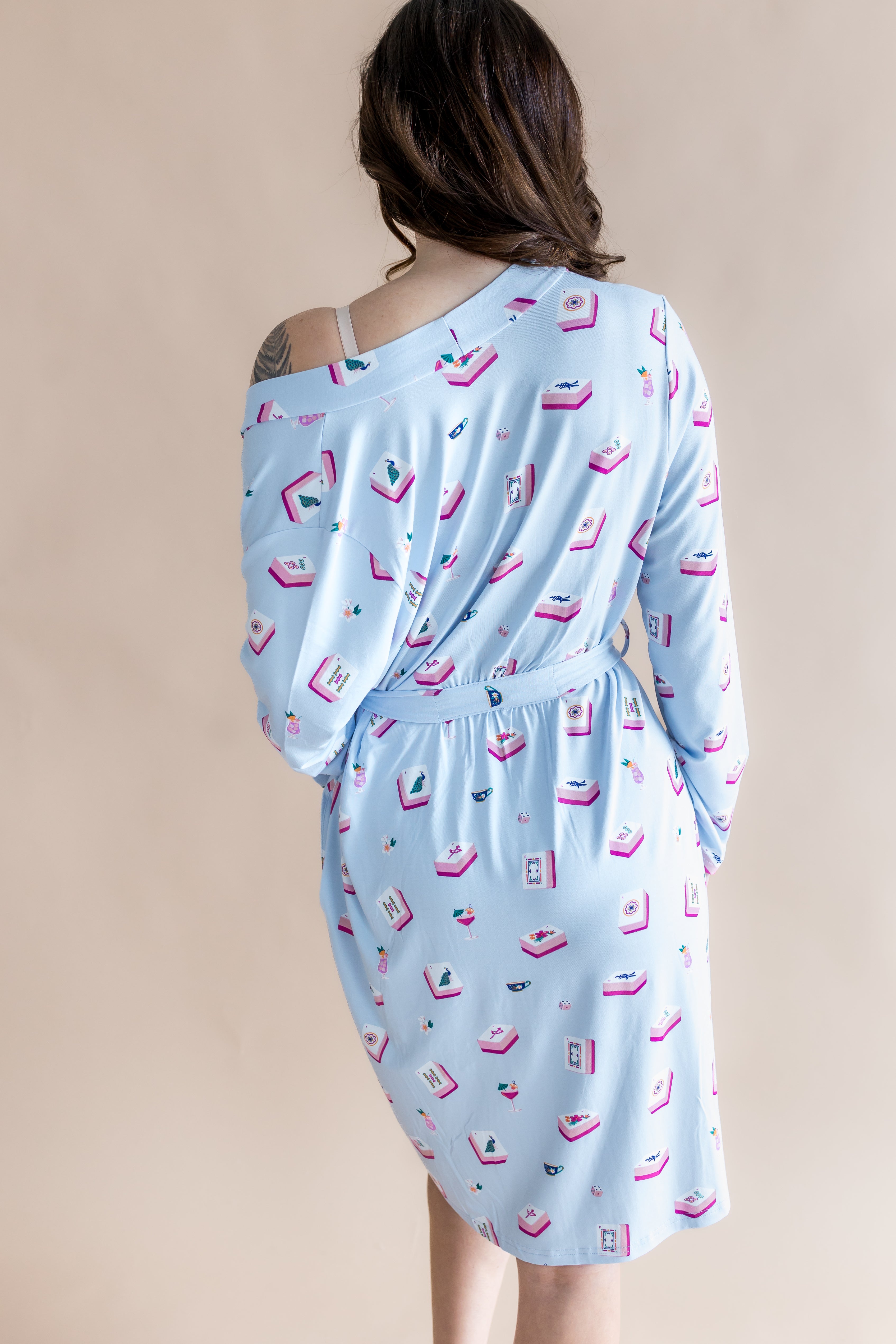 Light blue dress with mahjong patterns on a beige background