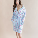 Woman wearing a light blue robe with pink mahjong tiles pattern on a beige background ::: Model is 5'7" wearing size XS/S ///