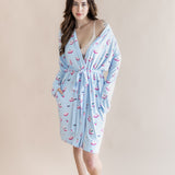 Woman wearing a light blue robe with pink mahjong tiles pattern on a beige background ::: Model is 5'7" wearing size XS/S ///