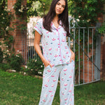 Woman wearing a mahjong pajama set outdoors with greenery in the background ::: Model is 5'10" wearing size S ///
