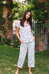 Woman wearing a mahjong pajama set outdoors with greenery in the background ::: Model is 5'10" wearing size S ///
