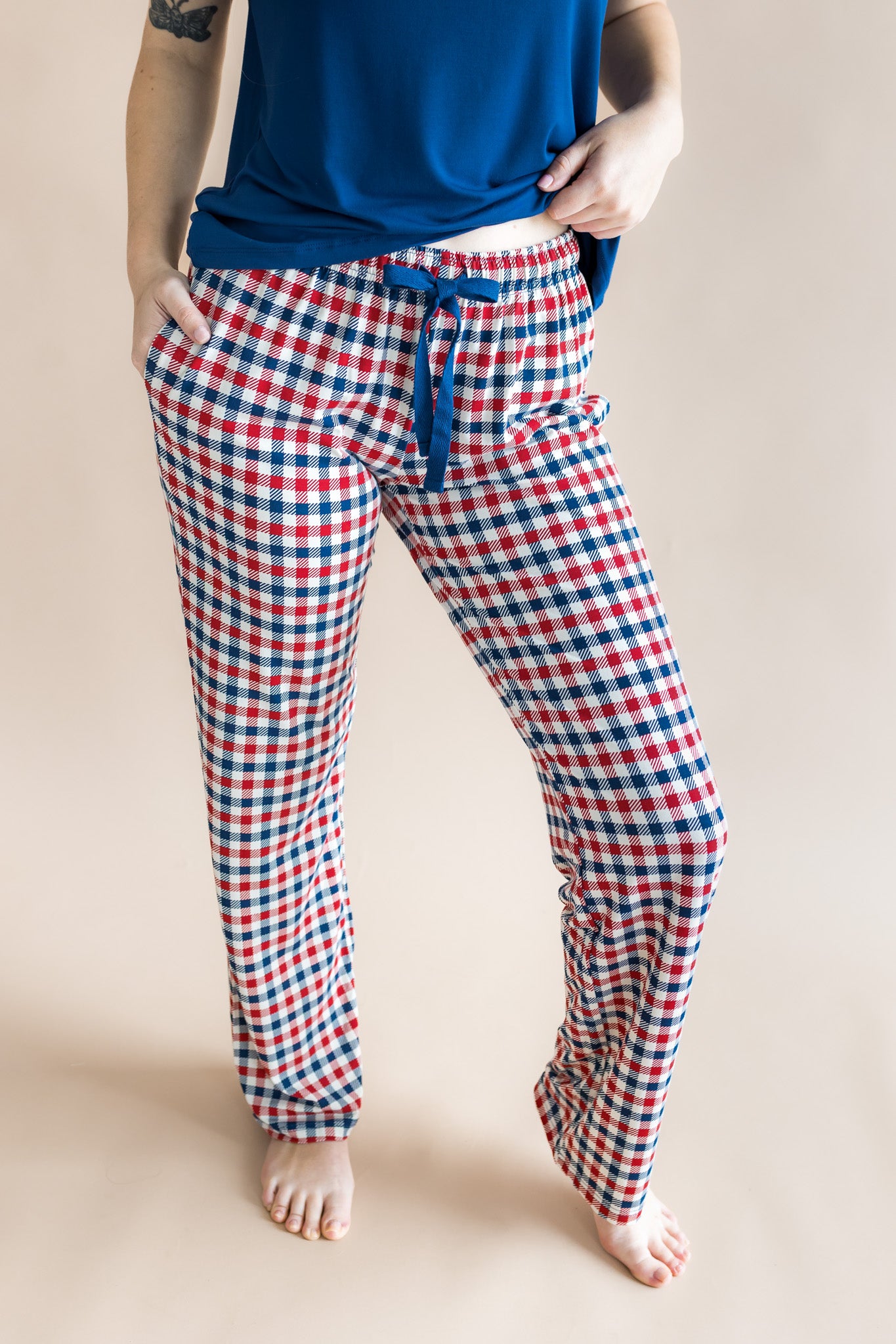 Close  up of model wearing the Women's Lounge Pants in Patriotic Gingham while on a model standing in front of a beige background

::: Model is 5'7" wearing size S ///
