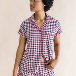 Model looking to the side while wearing the Women's Short Sleeve Pajama Set in Patriotic Gingham 