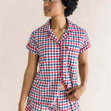 Model looking to the side while wearing the Women's Short Sleeve Pajama Set in Patriotic Gingham 