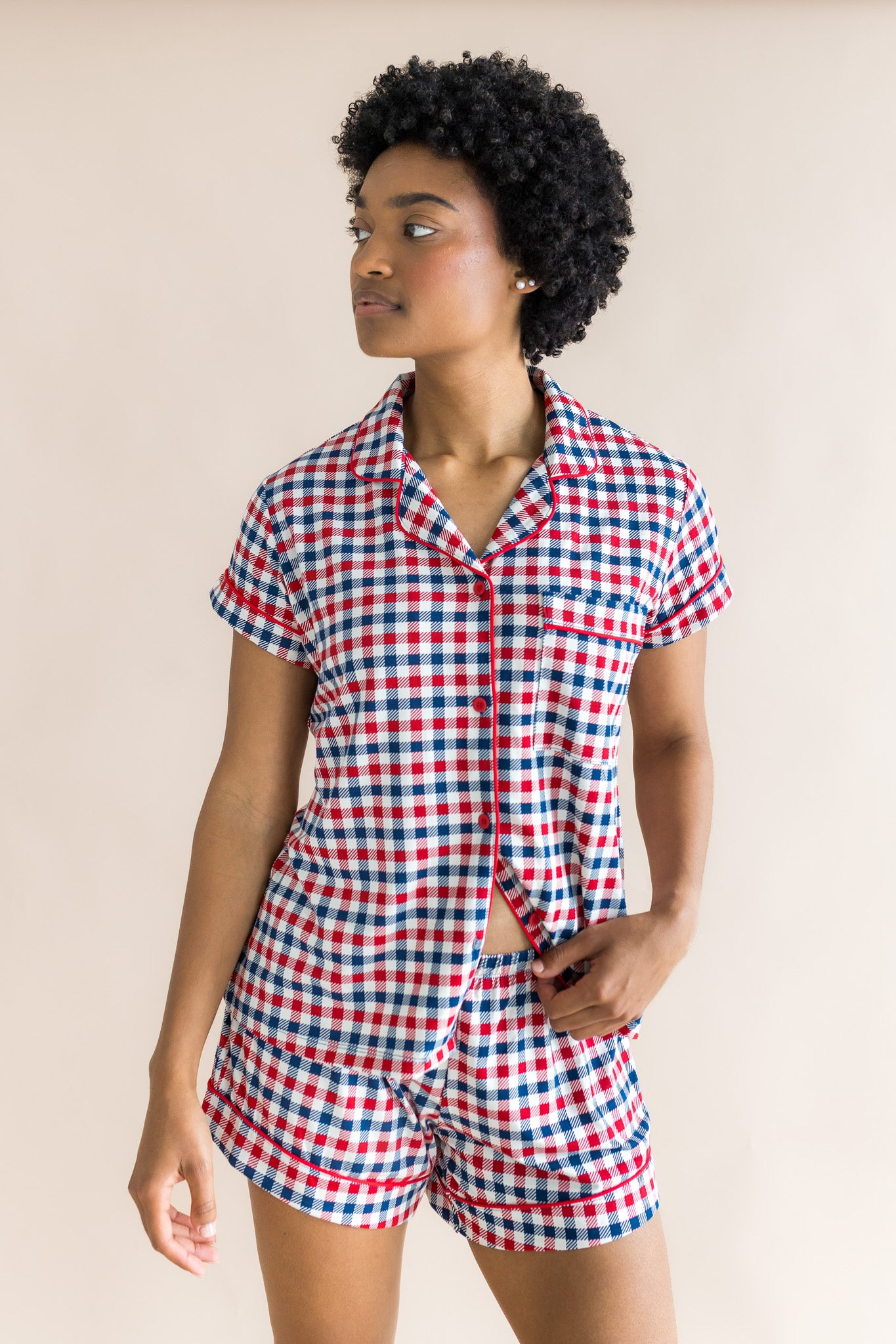 Model looking to the side while wearing the Women's Short Sleeve Pajama Set in Patriotic Gingham 