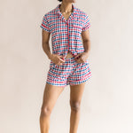 Woman looking sideways infront of a beige background while modeling the Women's Short Sleeve Pajama Set in Patriotic Gingham ::: Model is 5'9" wearing size S ///