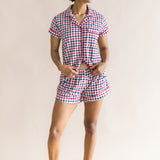 Woman looking sideways infront of a beige background while modeling the Women's Short Sleeve Pajama Set in Patriotic Gingham ::: Model is 5'9" wearing size S ///