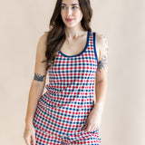 Model standing in front of a beige back ground while looking to the side and wearing the Kyte Women's Tank Set in Patriotic Gingham

::: Model is 5'7" wearing size S ///