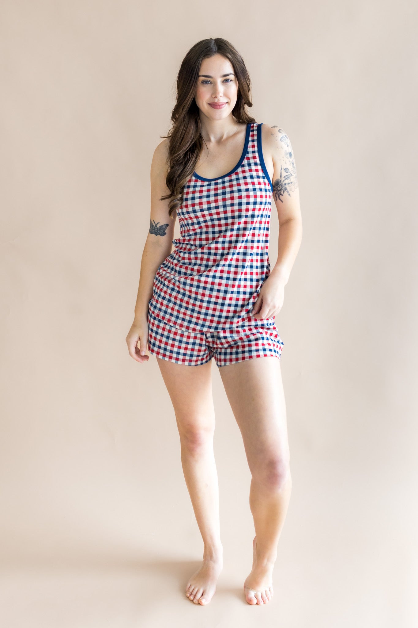 Full body of model wearing the Women's Tank Set in Patriotic Gingham with one hand on hip with a beige back ground 