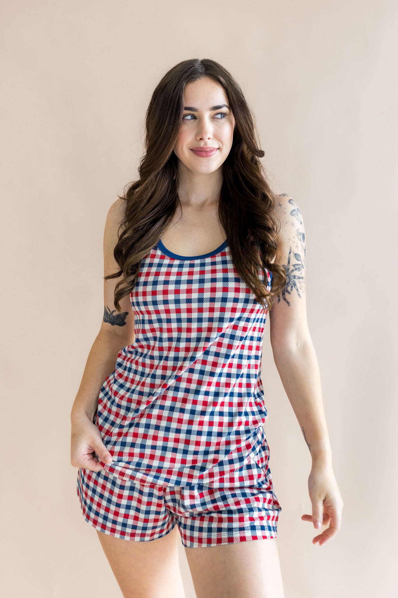 Brunette model smirking to the side while modeling the Women's Tank Set in Patriotic Gingham 