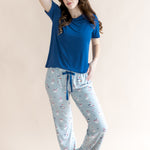 Model looking to the side with arm on her head and one knee bent while wearing the Women's Lounge Pants in Patriotic Goose paired with a crew neck in Tahoe 