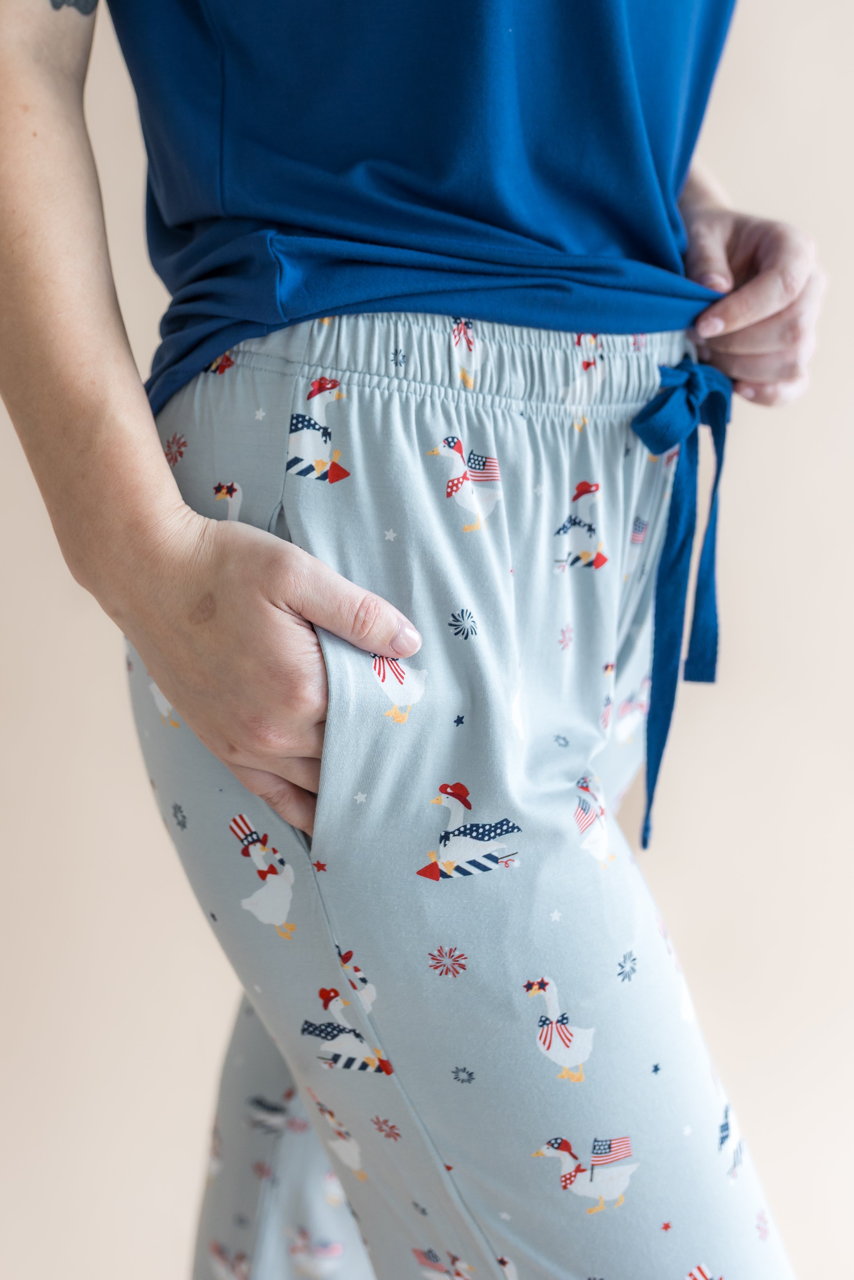 Close up of the model's hand in the pocket  of the Women's Lounge Pants in Patriotic Goose