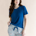 Woman looking to the side while modeling the Women's Lounge Pants in Patriotic Goose with hand on her hip 