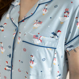 Close up of the top from the Women's Short Sleeve Pajama Set in Patriotic Goose showcasing the pocket and trim 