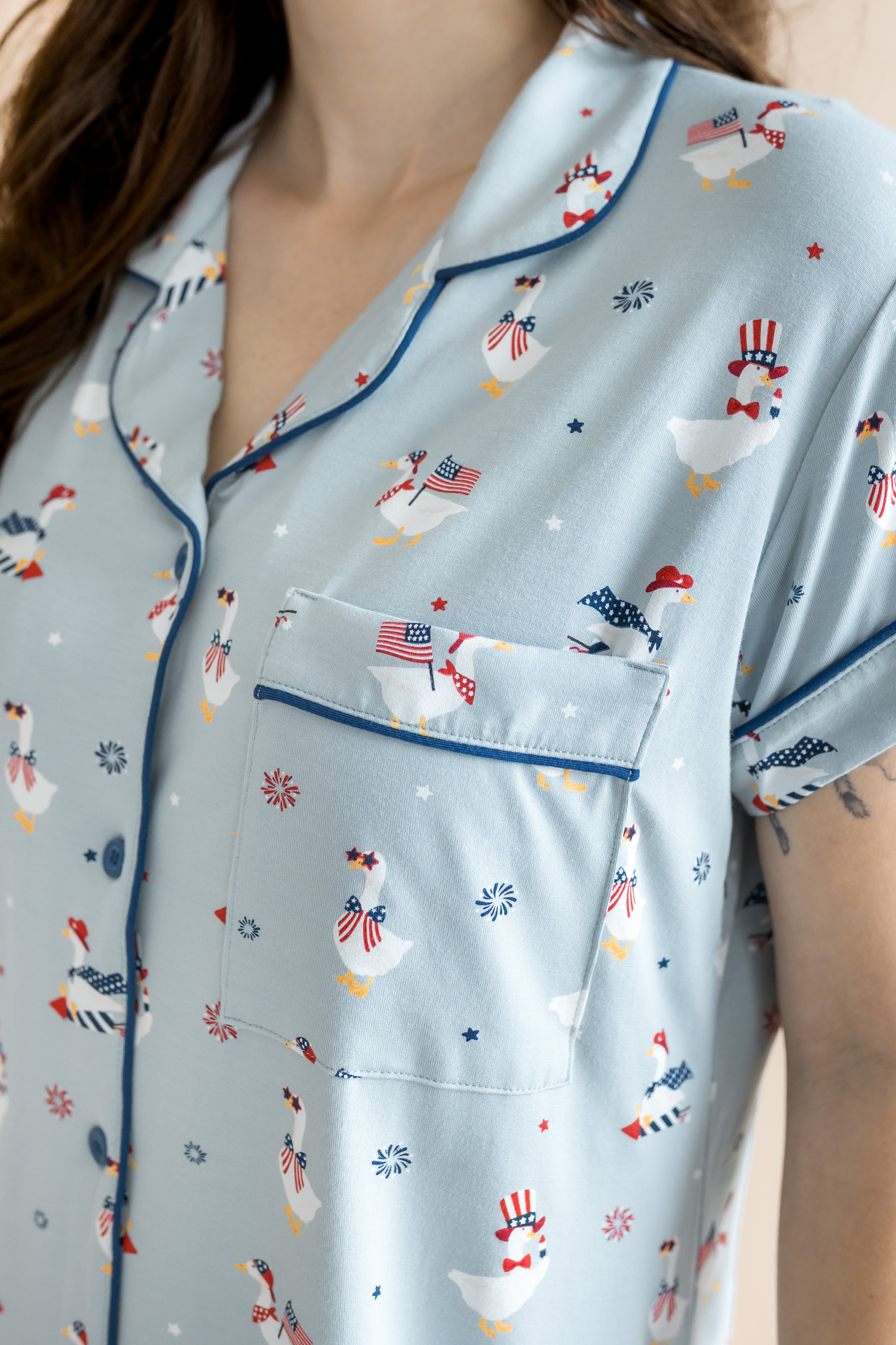 Close up of the top from the Women's Short Sleeve Pajama Set in Patriotic Goose showcasing the pocket and trim 