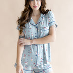 Model with one arm crossed in front of her body while wearing the Women's Short Sleeve Pajama Set in Patriotic Goose 

  ::: Model is 5'7" wearing size S ///
background