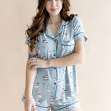 Model with one arm crossed in front of her body while wearing the Women's Short Sleeve Pajama Set in Patriotic Goose 

  ::: Model is 5'7" wearing size S ///
background