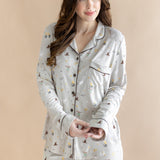 Close up of the model wearing the Long-Sleeved Women's Pajama Set in Starry Icon while she holds the wrist area of the top ::: Model is 5'7" wearing size S ///

