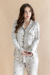 Close up of the model wearing the Long-Sleeved Women's Pajama Set in Starry Icon while she holds the wrist area of the top