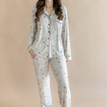 Model standing in front of a beige background while wearing the Long-Sleeved Women's Pajama Set in Starry Icon

::: Model is 5'7" wearing size S ///
