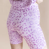 Back side of Women’s Biker Short Set shorts in Thistle Leopard print on a beige background