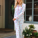 Woman wearing a mahjong patterned pajama set standing outside a house with plants around. ::: Model is 5'9" wearing size XS ///