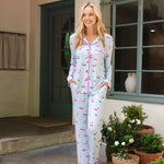 Woman modeling mahjong patterned pajama set in an outdoor home setting