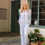 Woman modeling mahjong patterned pajama set in an outdoor home setting