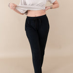 Woman modeling Women's Jogger Pants in Midnight showing off waist band