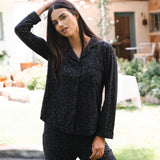 Woman wearing a black leopard patterned outfit standing outdoors. ::: Model is 5'10" wearing size S ///