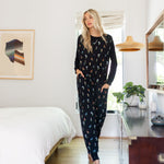 Model standing in Adult sleeveless Sleep Bag Walker in Midnight Wildflower in a room