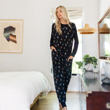 Model standing in Adult sleeveless Sleep Bag Walker in Midnight Wildflower in a room