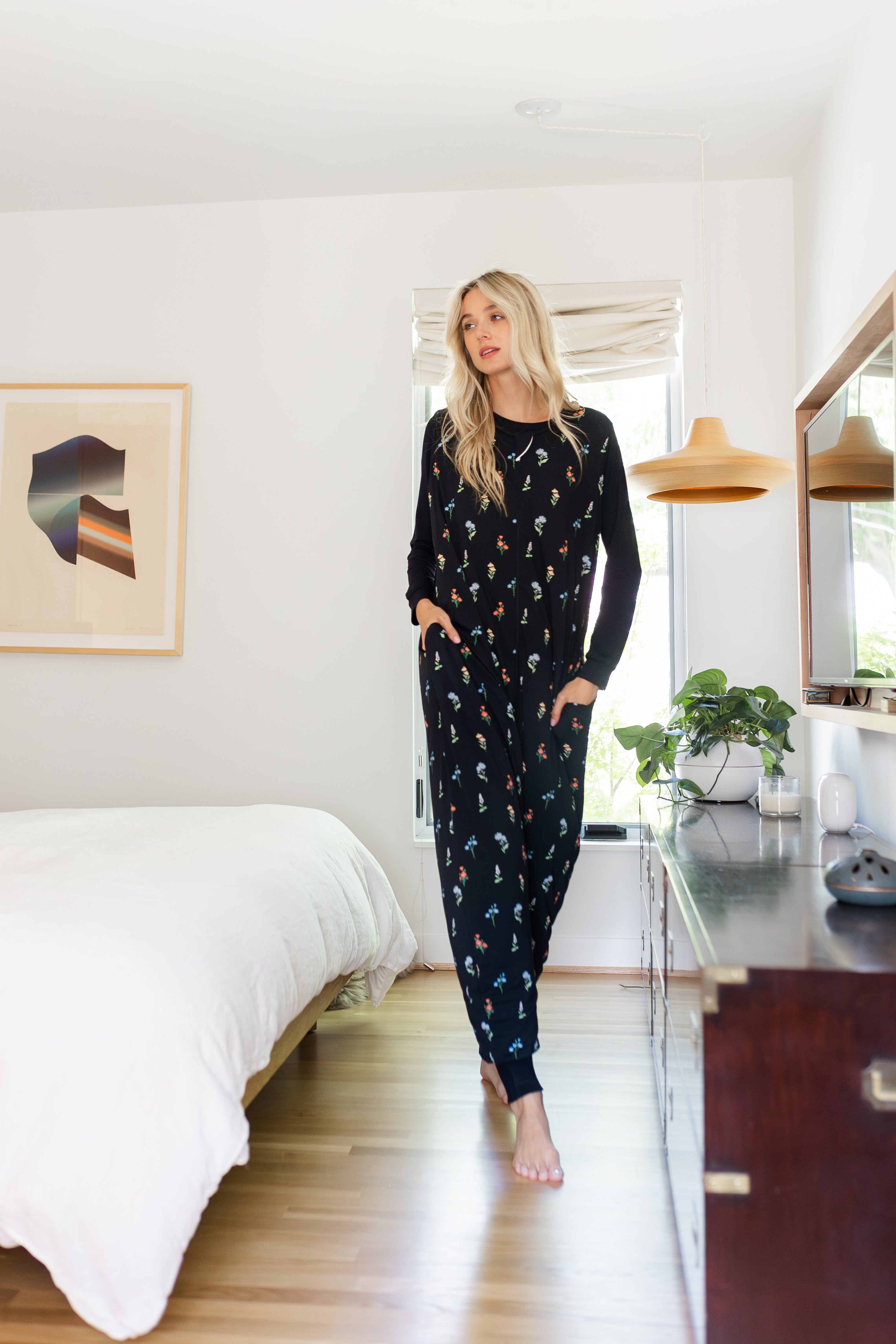 Model standing in Adult sleeveless Sleep Bag Walker in Midnight Wildflower in a room
